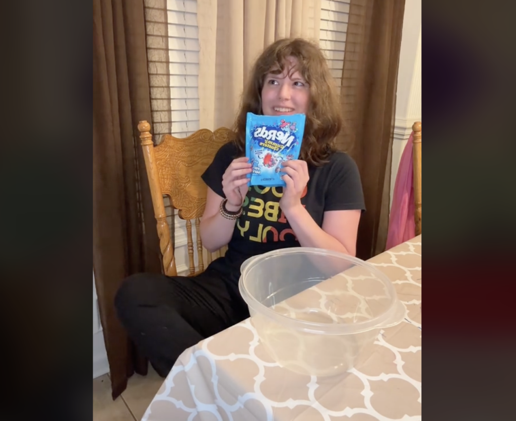 Woman in a TikTok video holding candy bag